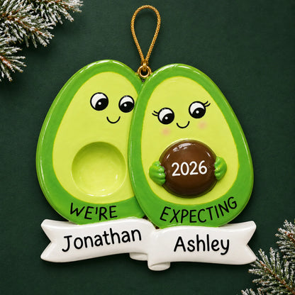 Personalized Avocado Expecting Couple christmas ornament on a dark green pine background