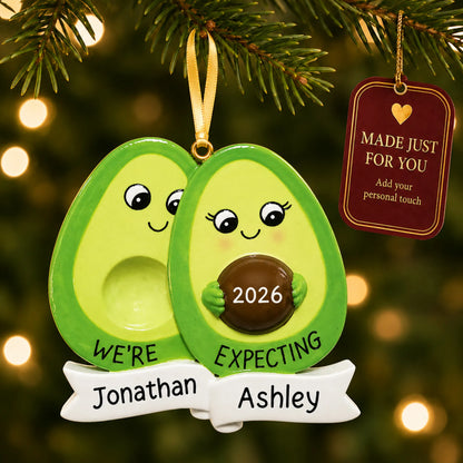Avocado Expecting Couple christmas ornament hanging on a lit Christmas tree with a Made Just For You gift tag