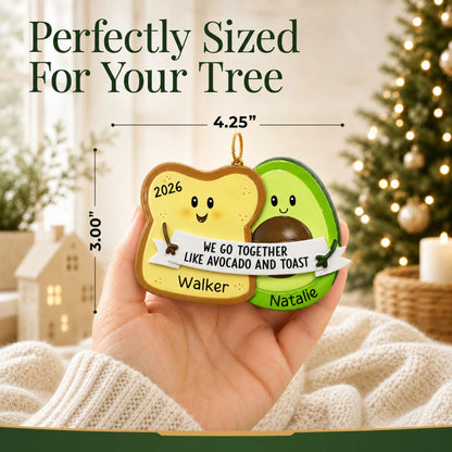 Size guide: the personalized Avocado & Toast christmas ornament is 4.25 in wide by 3.00 in tall, shown in hand