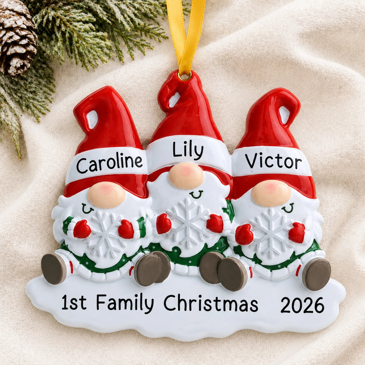 Personalized gnome family of 3 christmas ornament laid on a soft white knit blanket