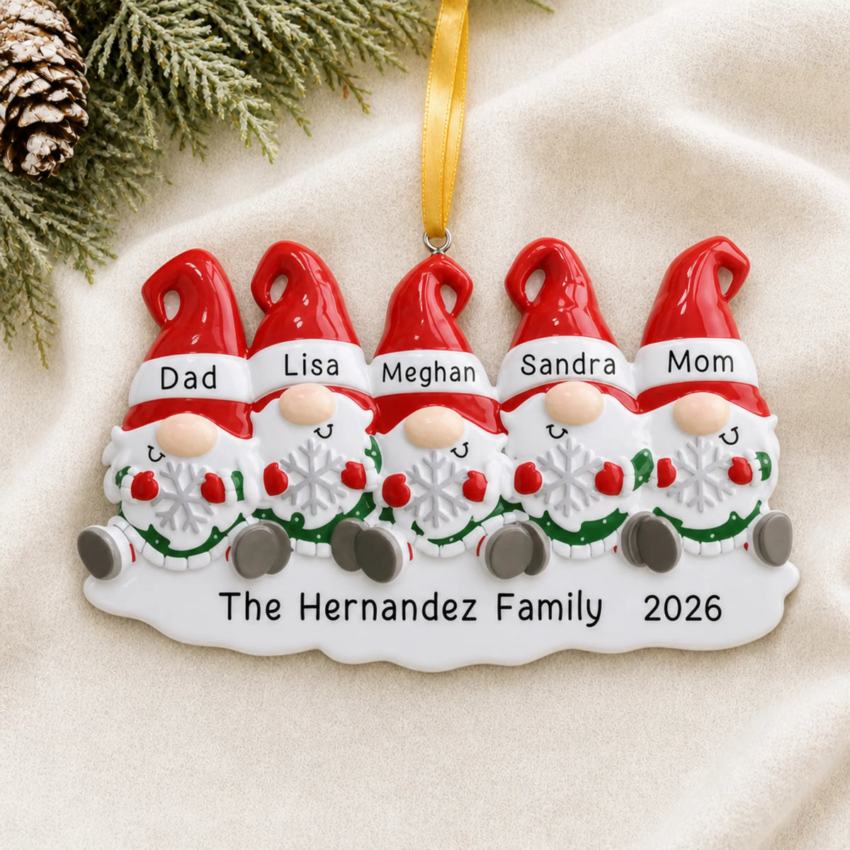 Personalized gnome family of 5 christmas ornament laid on a soft white knit blanket