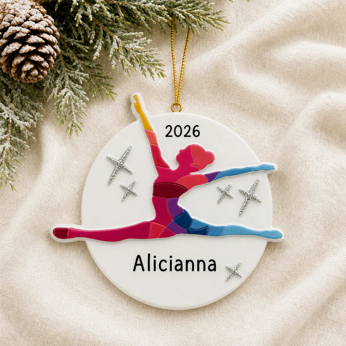 Personalized dance pose christmas ornament laid on a soft white knit blanket