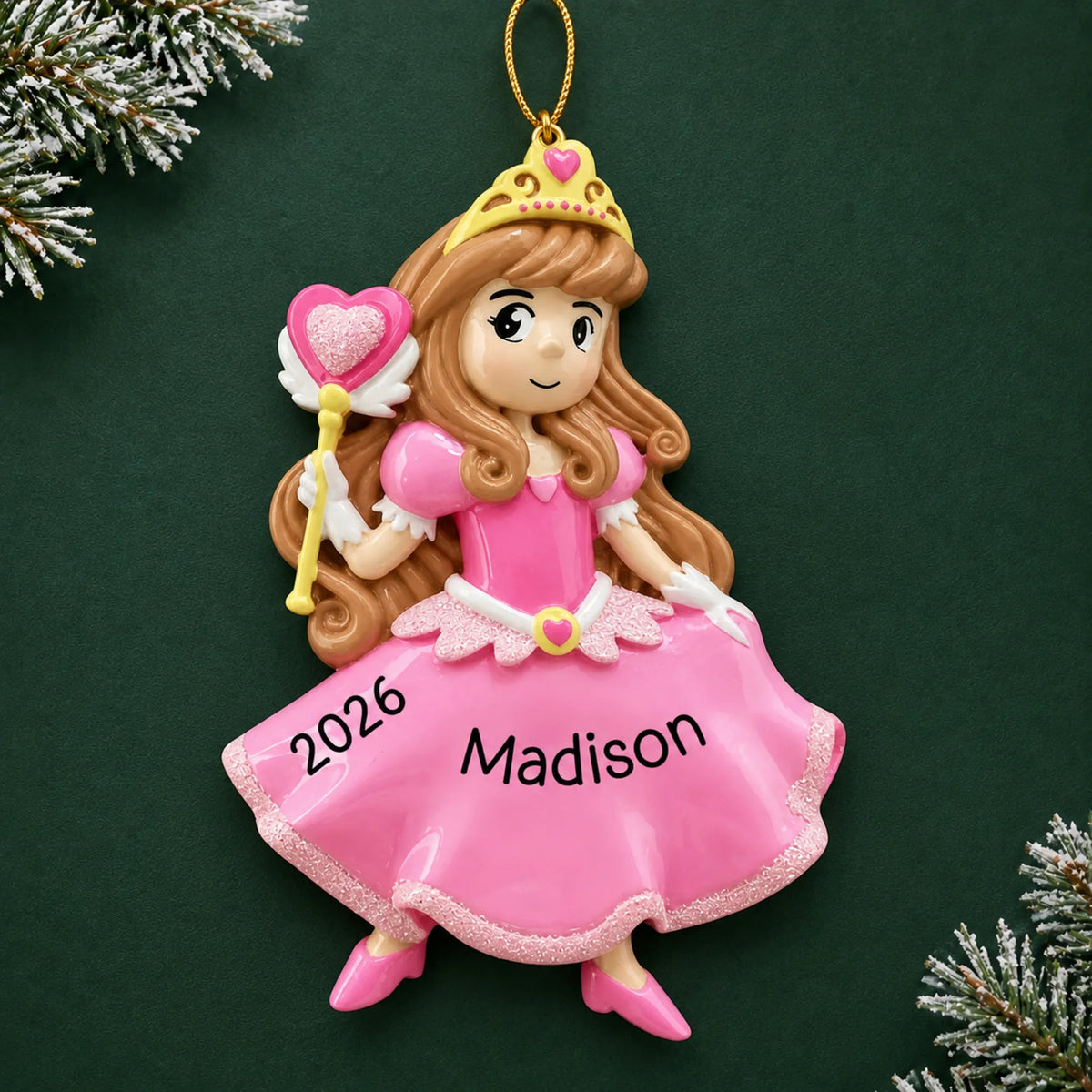 Personalized pink princess christmas ornament on a dark green pine background