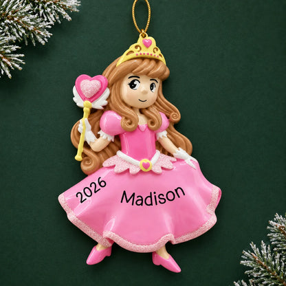 Personalized pink princess christmas ornament on a dark green pine background