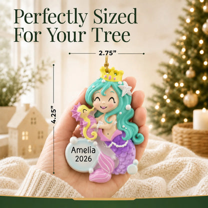 Size guide: the personalized mermaid girl christmas ornament is 2.75 in wide by 4.25 in tall, shown in hand