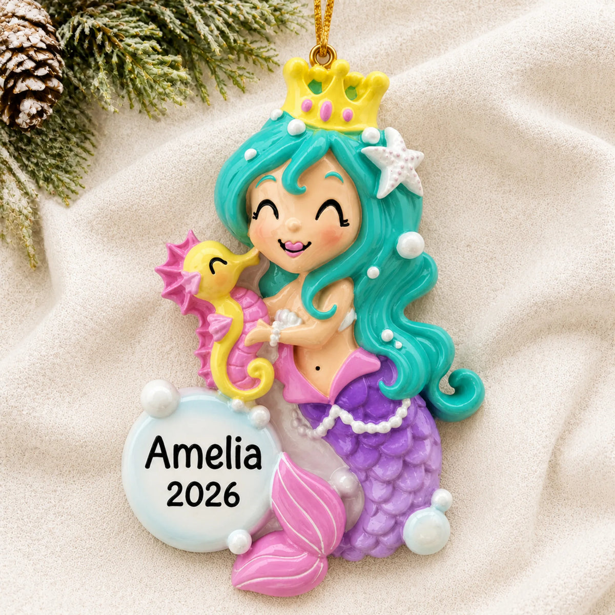 Personalized mermaid girl christmas ornament laid on a soft white knit blanket