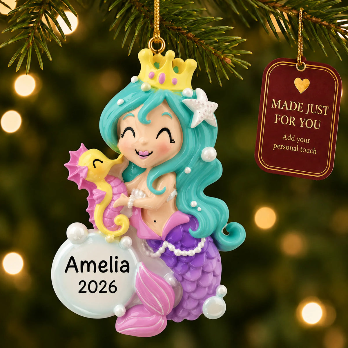 Mermaid girl christmas ornament hanging on a lit Christmas tree with a Made Just For You gift tag