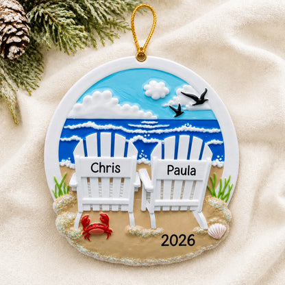 Personalized beach adirondack chair couple christmas ornament laid on a soft white knit blanket