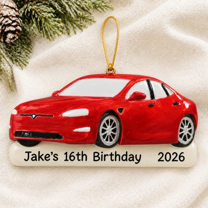 Personalized Red Sports Car christmas ornament laid on a soft white knit blanket