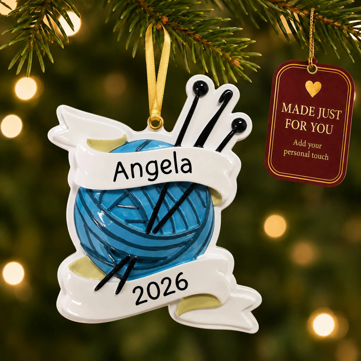 Knitting yarn and needles christmas ornament hanging on a lit Christmas tree with a Made Just For You gift tag