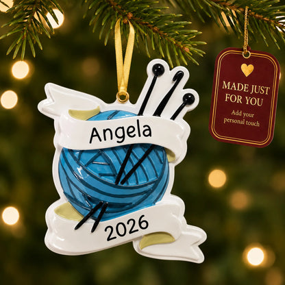 Knitting yarn and needles christmas ornament hanging on a lit Christmas tree with a Made Just For You gift tag