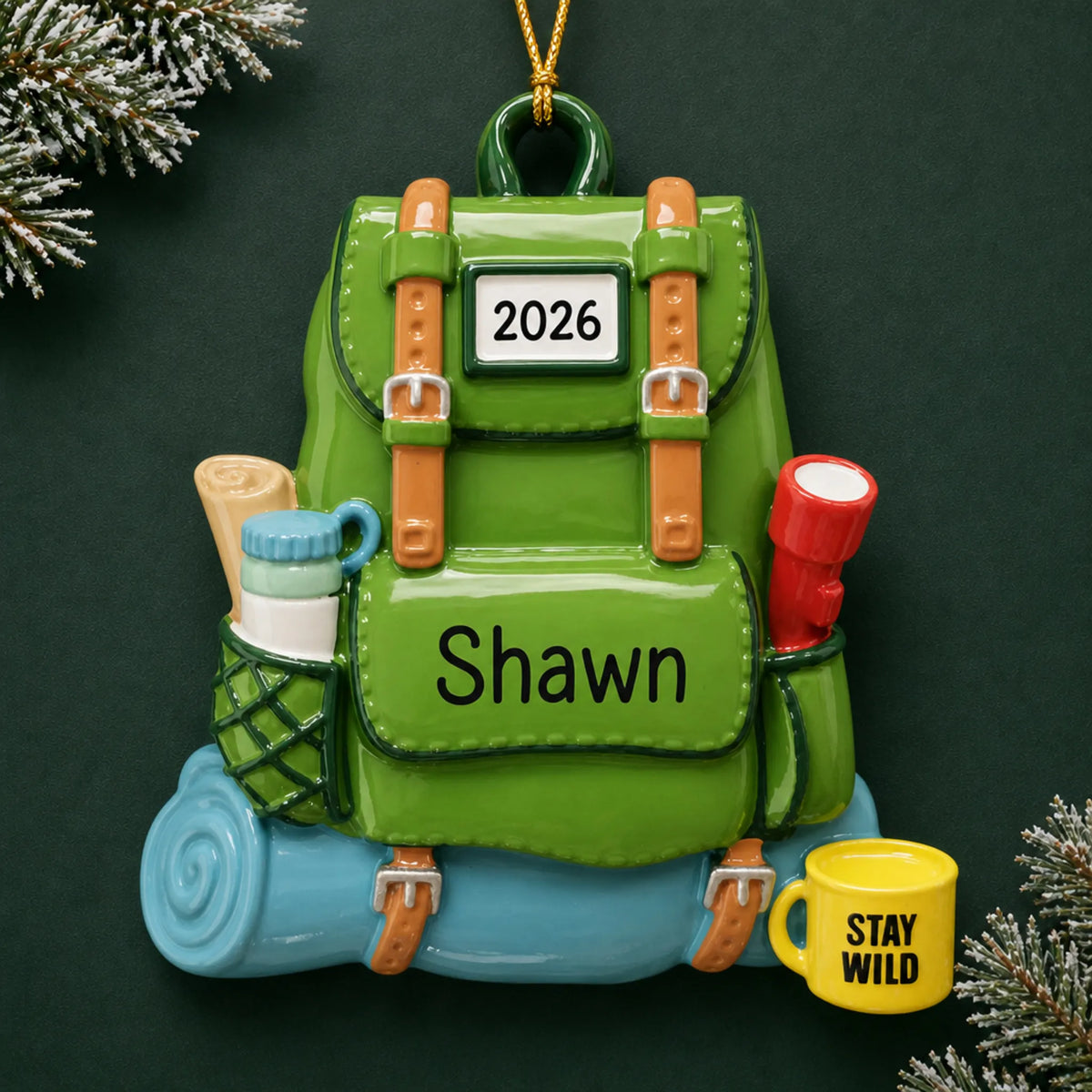 Personalized hiking backpack christmas ornament on a dark green pine background