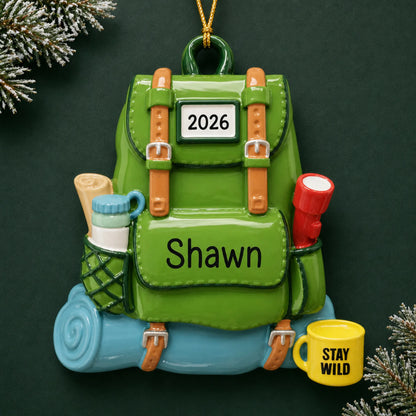 Personalized hiking backpack christmas ornament on a dark green pine background