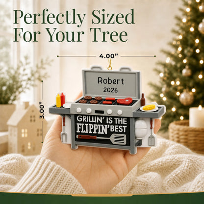 Size guide: the personalized BBQ Grilling christmas ornament is 4.00 in wide by 3.00 in tall, shown in hand