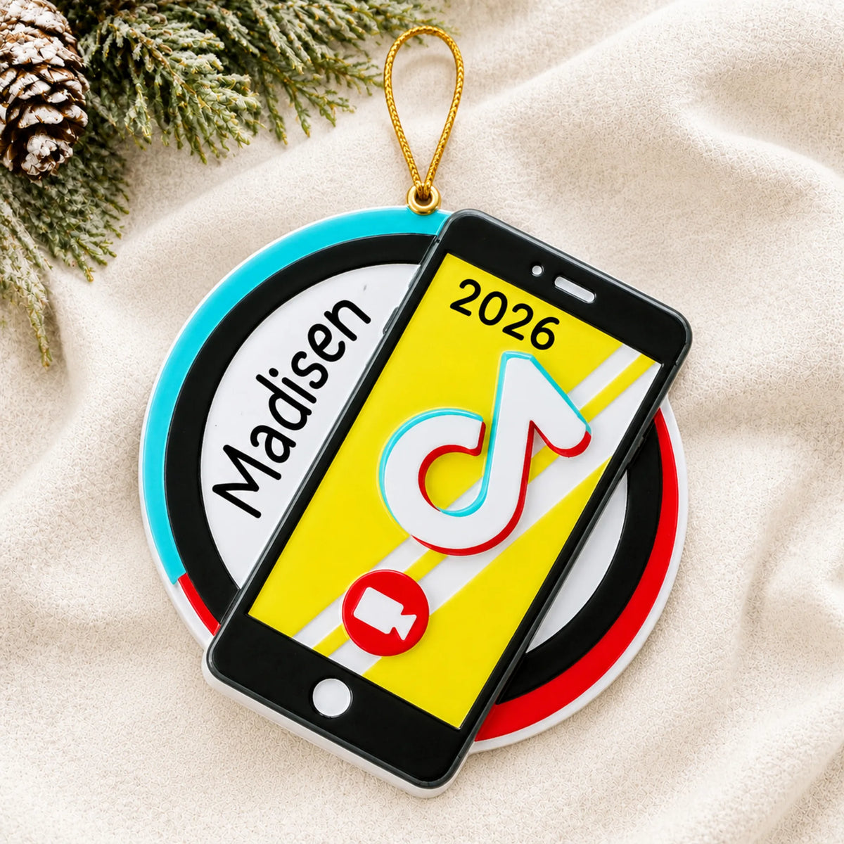 Personalized viral video star christmas ornament laid on a soft white knit blanket