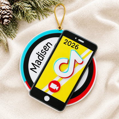 Personalized viral video star christmas ornament laid on a soft white knit blanket