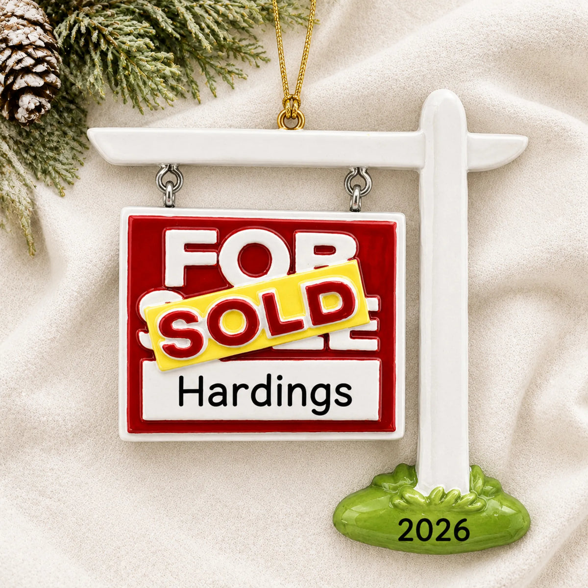 Personalized For Sale Sold New Home christmas ornament laid on a soft white knit blanket