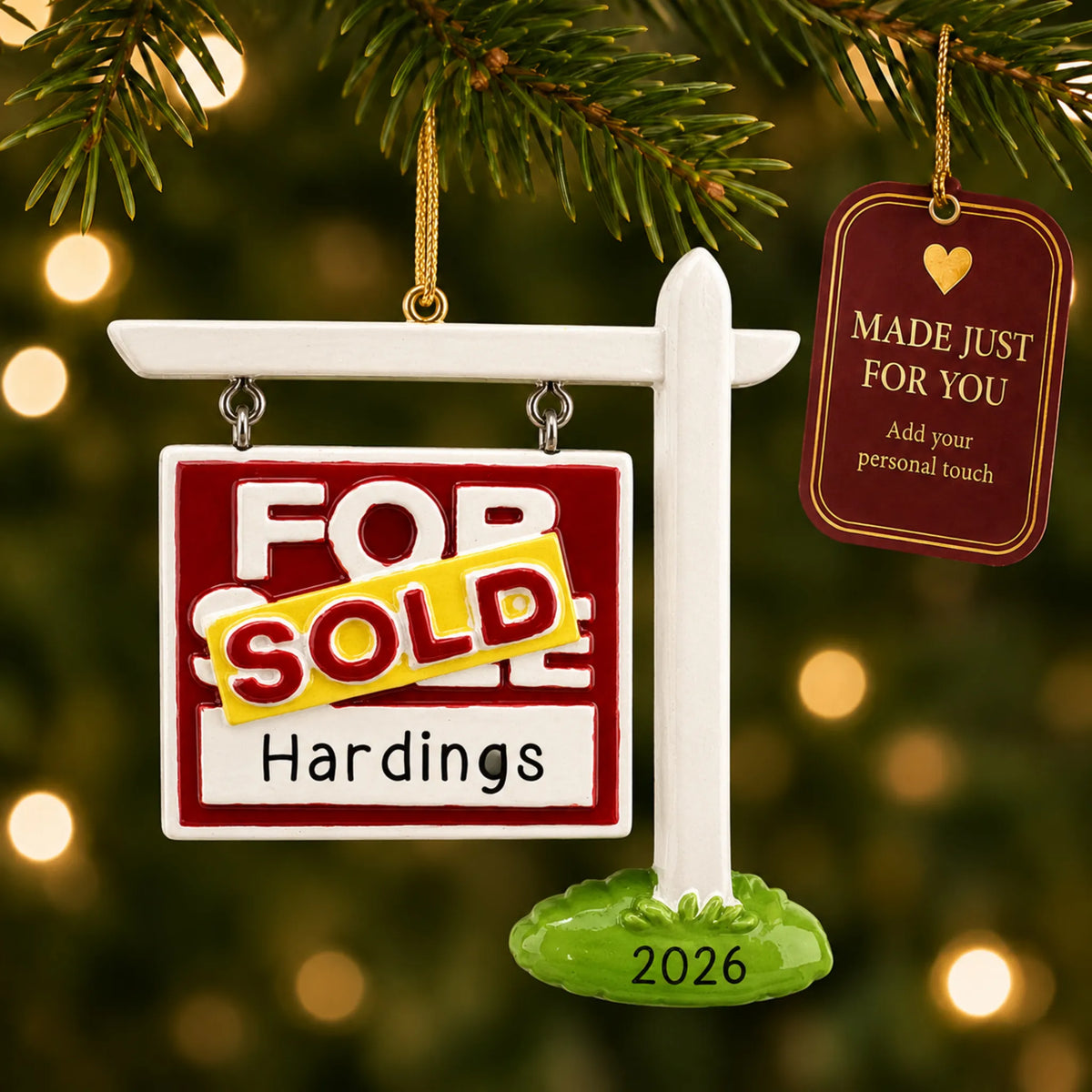 For Sale Sold New Home christmas ornament hanging on a lit Christmas tree with a Made Just For You gift tag