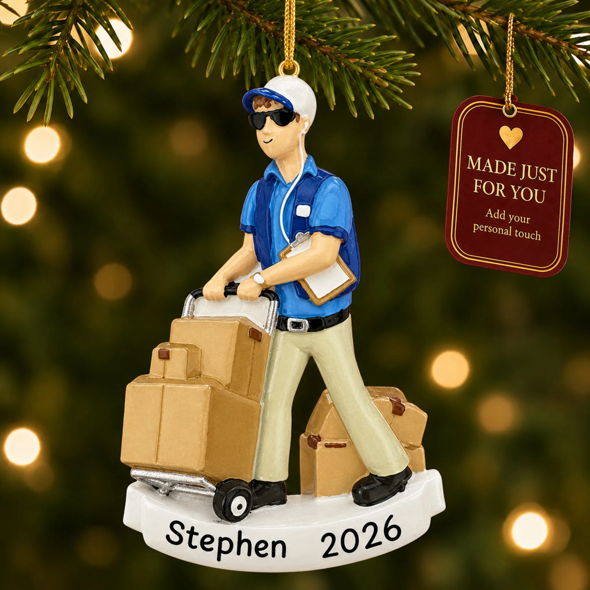 Amazon delivery guy christmas ornament hanging on a lit Christmas tree with a Made Just For You gift tag
