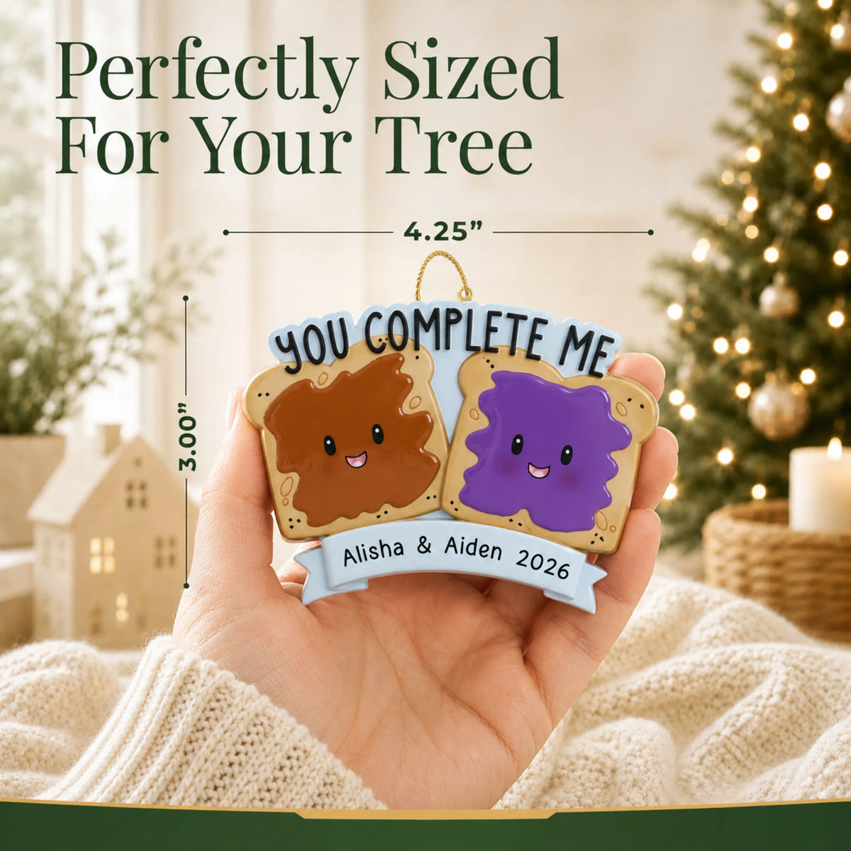 Size guide: the personalized Peanut Butter & Jelly Couple christmas ornament is 4.25 in wide by 3.00 in tall, shown in hand