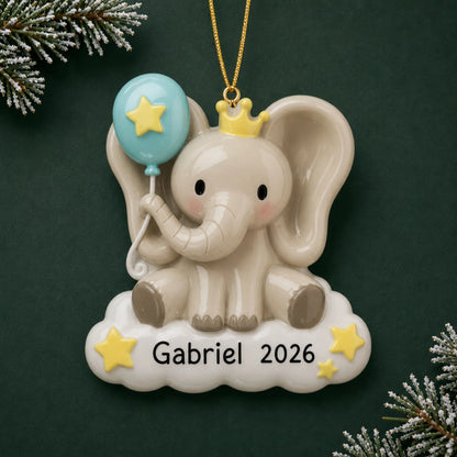 Personalized baby boy elephant christmas ornament on a dark green pine background