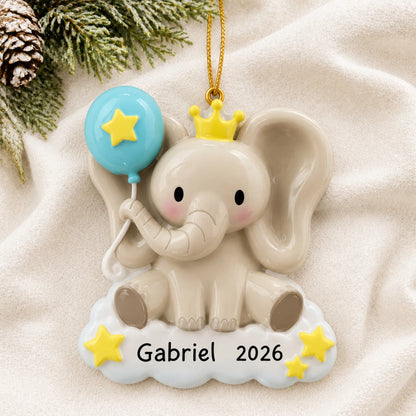 Personalized baby boy elephant christmas ornament laid on a soft white knit blanket