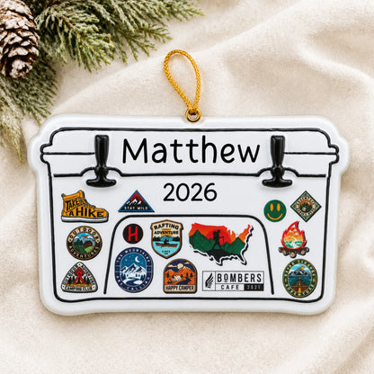 Personalized Yeti cooler christmas ornament laid on a soft white knit blanket
