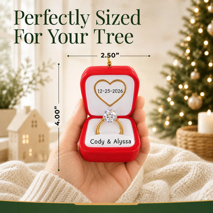 Size guide: the personalized Engagement Ring christmas ornament is 2.50 in wide by 4.00 in tall, shown in hand