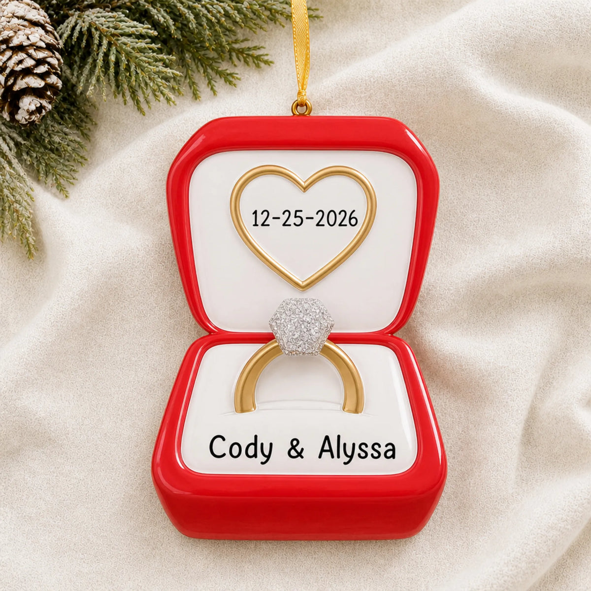 Personalized Engagement Ring christmas ornament laid on a soft white knit blanket