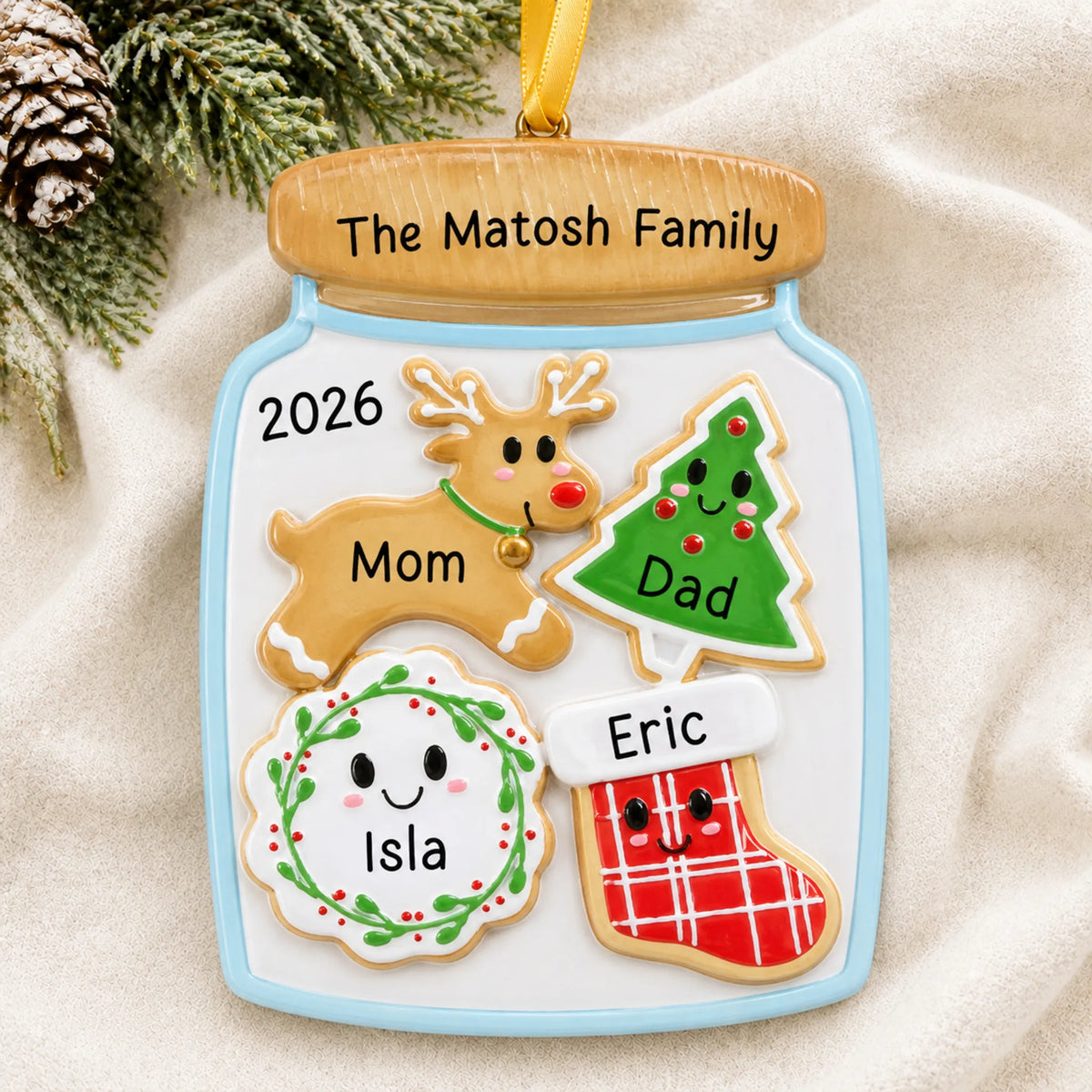 Personalized cookie jar family of 4 christmas ornament laid on a soft white knit blanket