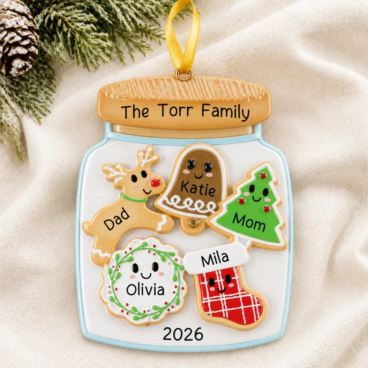 Personalized cookie jar family of 5 christmas ornament laid on a soft white knit blanket