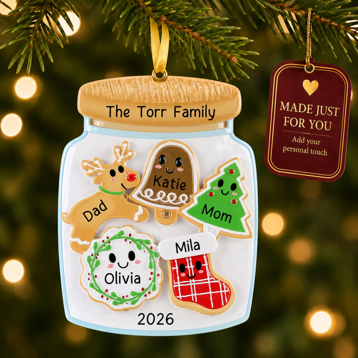Cookie jar family of 5 christmas ornament hanging on a lit Christmas tree with a Made Just For You gift tag