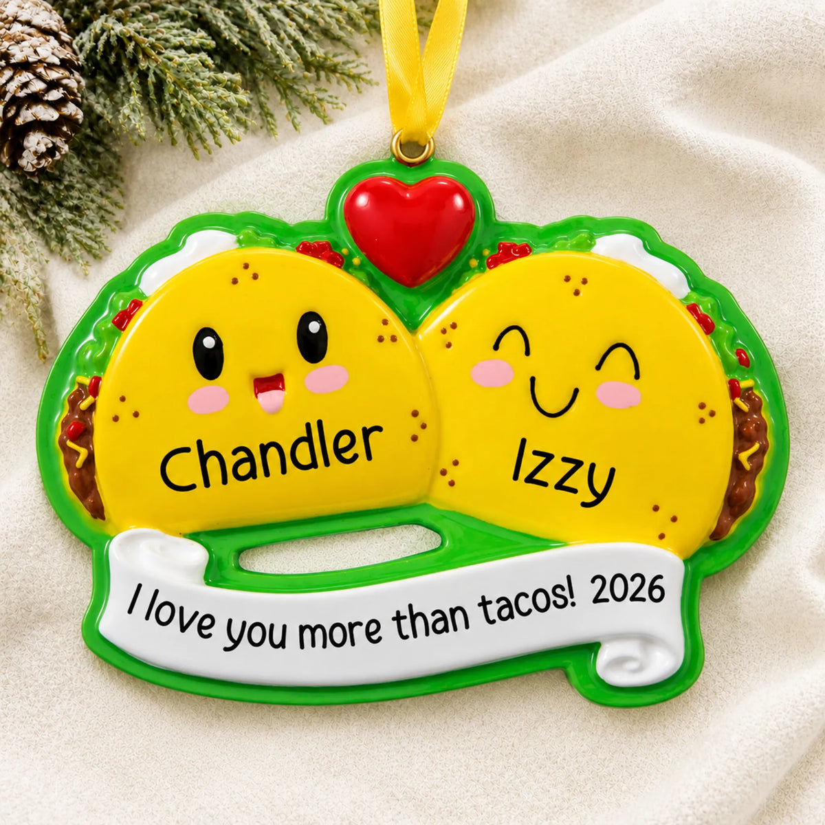Personalized taco couple christmas ornament laid on a soft white knit blanket