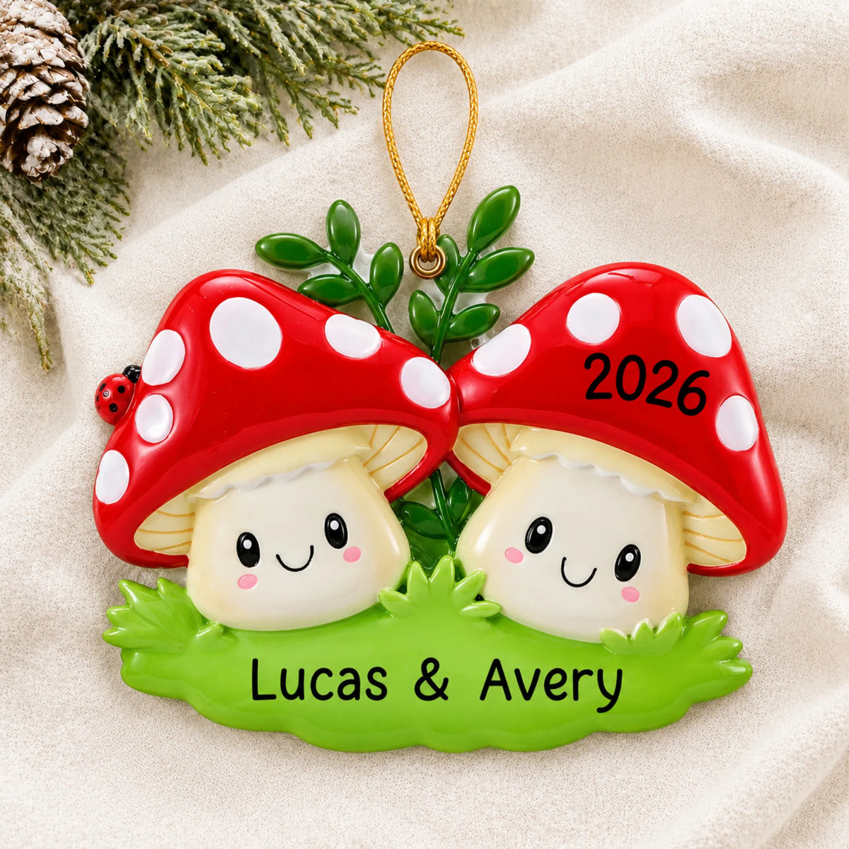 Personalized mushroom couple christmas ornament laid on a soft white knit blanket