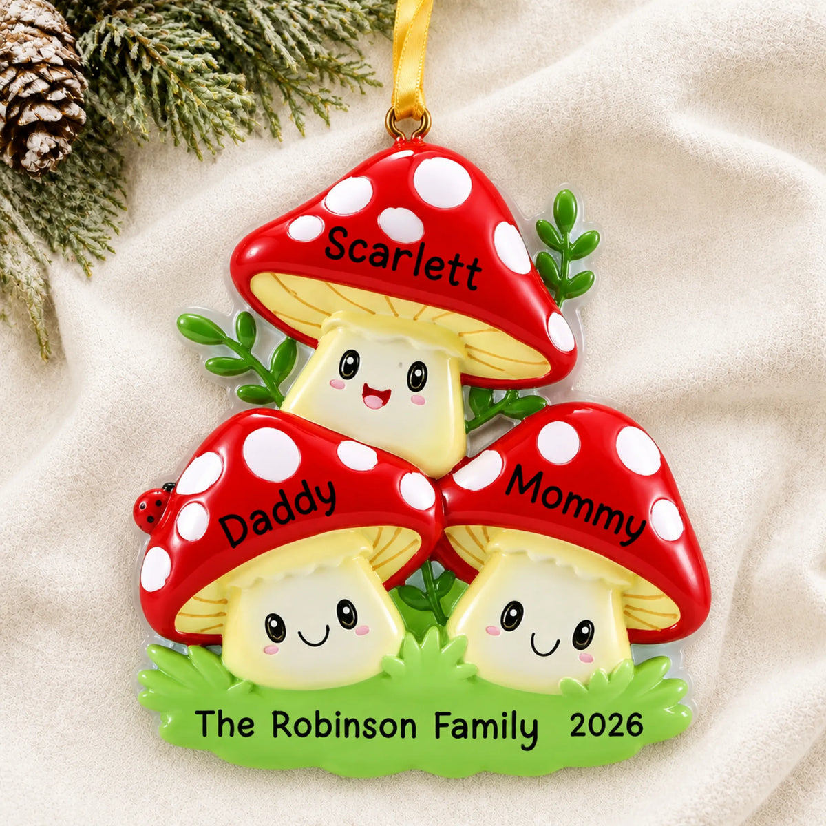 Personalized mushroom family of 3 christmas ornament laid on a soft white knit blanket