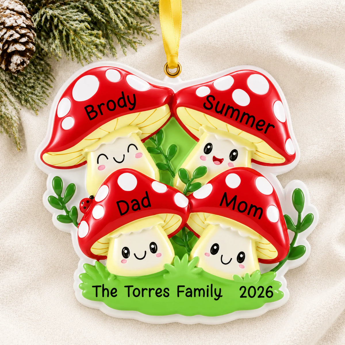 Personalized mushroom family of 4 christmas ornament laid on a soft white knit blanket