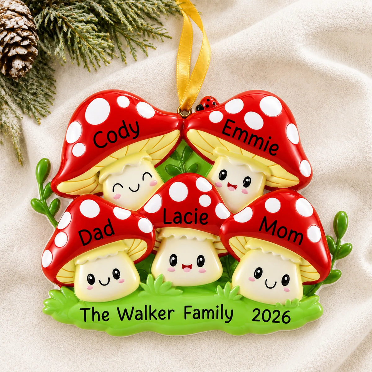 Personalized mushroom family of 5 christmas ornament laid on a soft white knit blanket