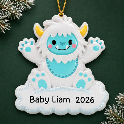 Personalized blue baby boy yeti christmas ornament on a dark green pine background