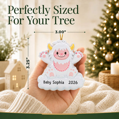 Size guide: the personalized pink baby girl yeti christmas ornament is 3.00 in wide by 3.25 in tall, shown in hand