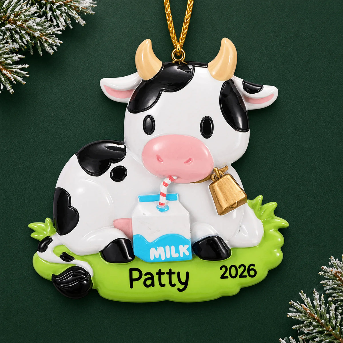 Personalized dairy cow christmas ornament on a dark green pine background