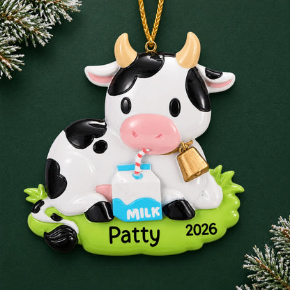 Personalized dairy cow christmas ornament on a dark green pine background