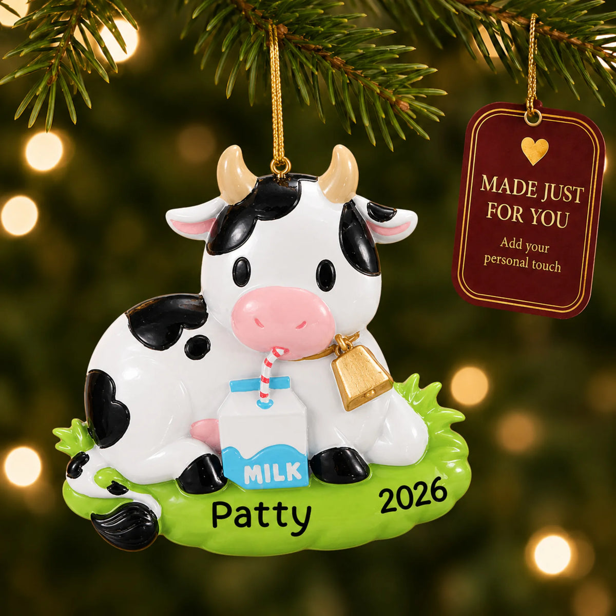 Dairy cow christmas ornament hanging on a lit Christmas tree with a Made Just For You gift tag