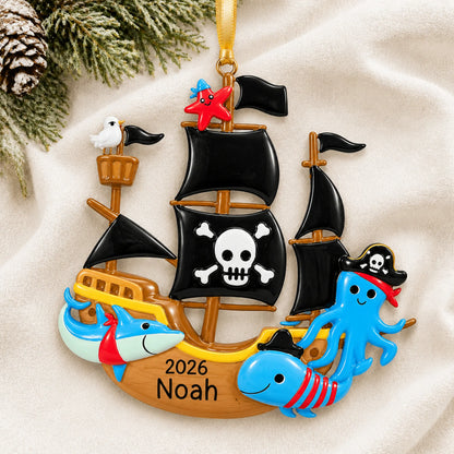 Personalized pirate ship christmas ornament laid on a soft white knit blanket
