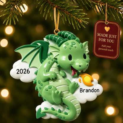 Green dragon christmas ornament hanging on a lit Christmas tree with a Made Just For You gift tag