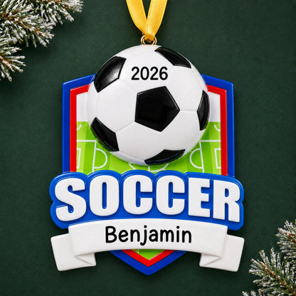 Personalized soccer shield christmas ornament on a dark green pine background
