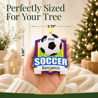 Size guide: the personalized soccer shield christmas ornament is 2.75 in wide by 3.50 in tall, shown in hand