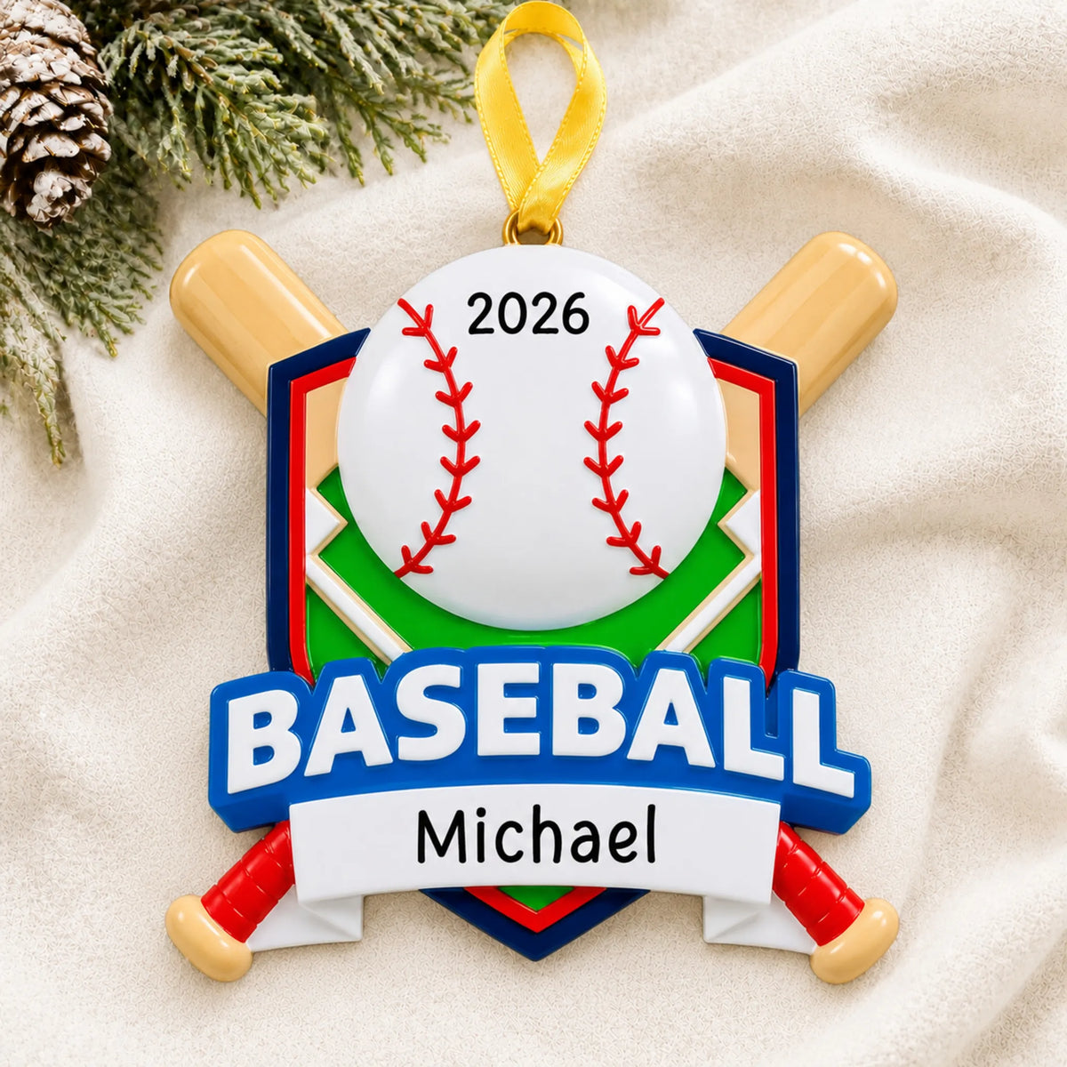 Personalized baseball crossed bats christmas ornament laid on a soft white knit blanket
