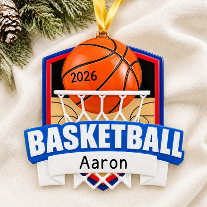 Personalized basketball shield christmas ornament laid on a soft white knit blanket