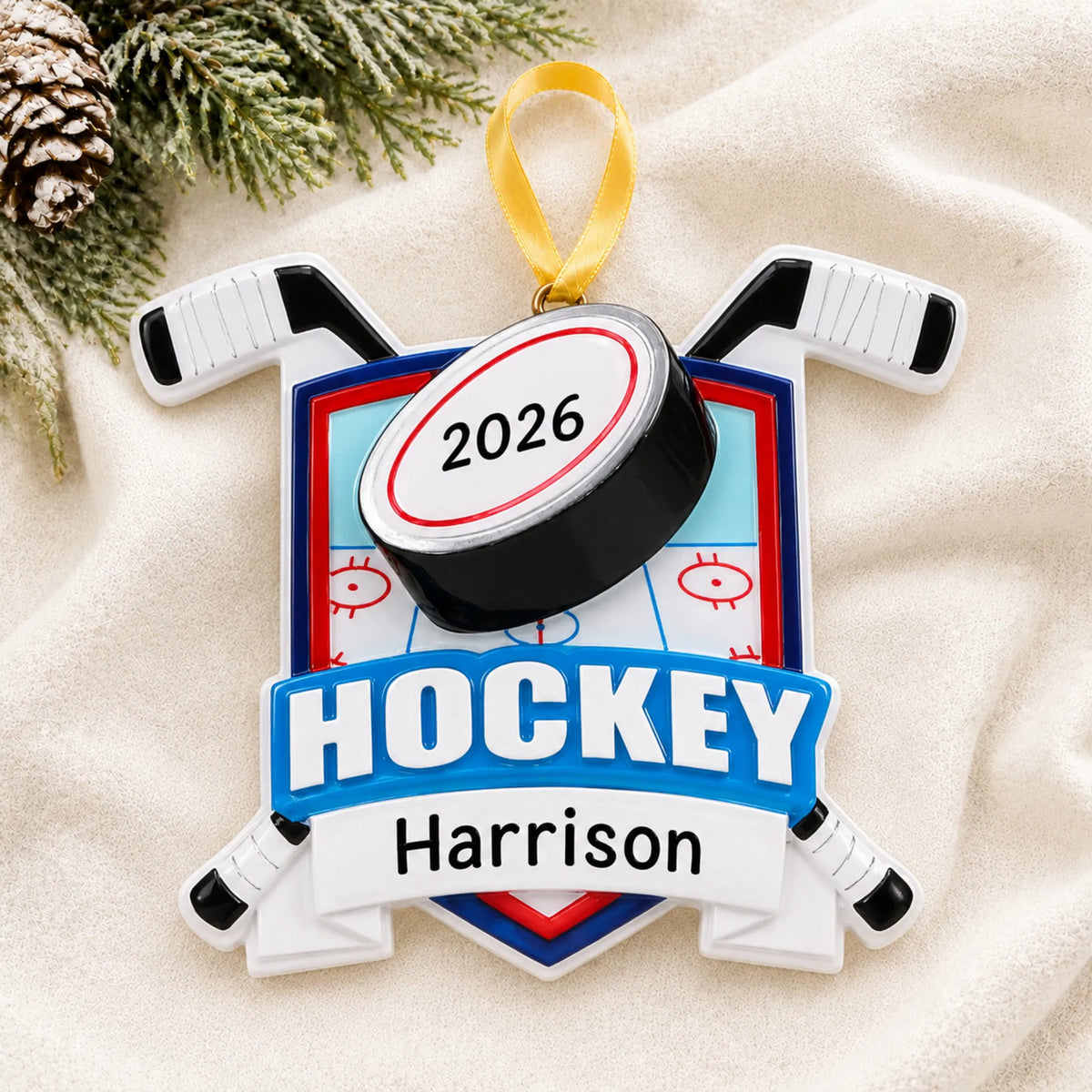 Personalized ice hockey collage christmas ornament laid on a soft white knit blanket