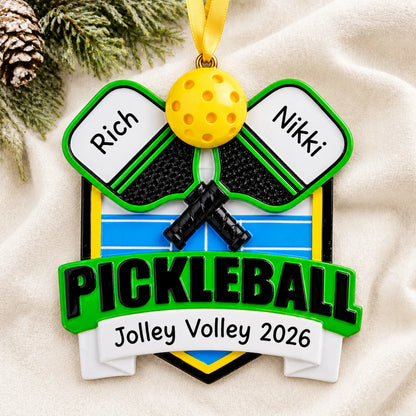 Personalized pickleball christmas ornament laid on a soft white knit blanket
